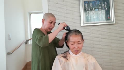 Old woman headshave at home