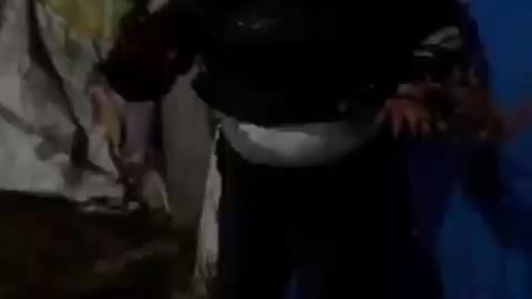 Footage of protesters beating police officers in Almaty.