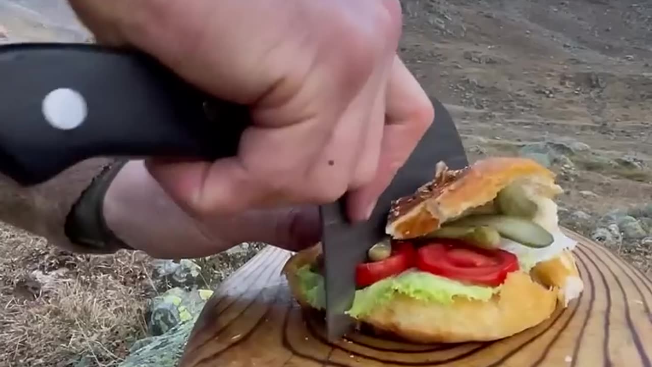 Cooking beef sausage burgers on the mountain