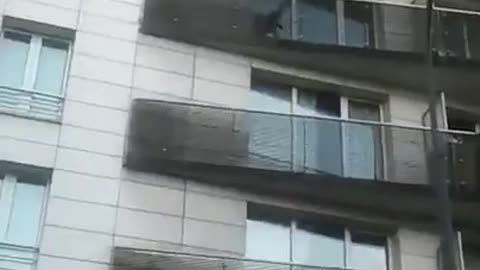 Man climbs building to save dangling child