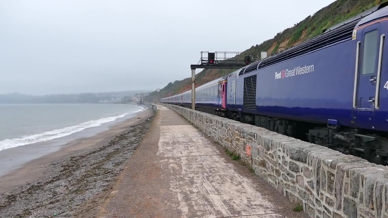 A Train Running Along Side of Beach