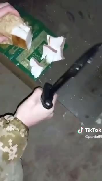 Ukrainian soldiers cut pork lard on the Koran