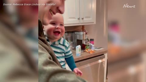 Baby laughs uncontrollably with dad