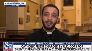 Priest charged after praying for free speech