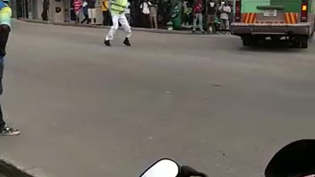 A creative traffic officer in Dar es Salaam leading transport vehicles for special entertainment