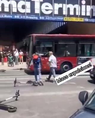 Migrant blocks traffic in Rome, Italy, and demands money from drivers to let cars pass.