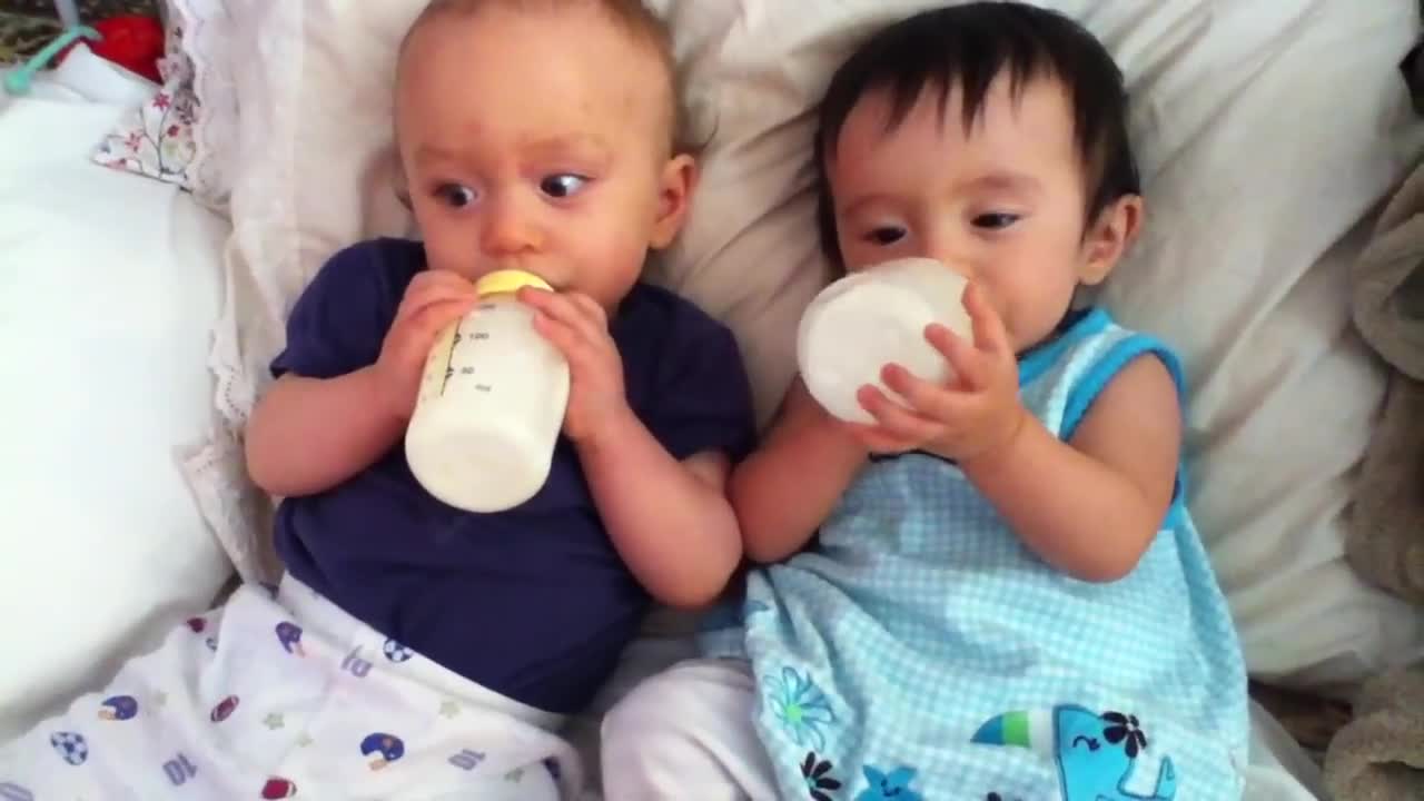 Twin babies drinking milk after nap