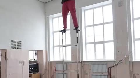 Guy Balances a Rose On His Forehead And Climbs Circus Ladder