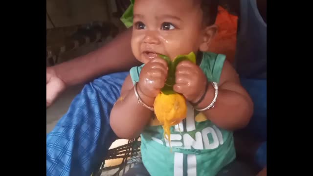 Small baby with mango eating