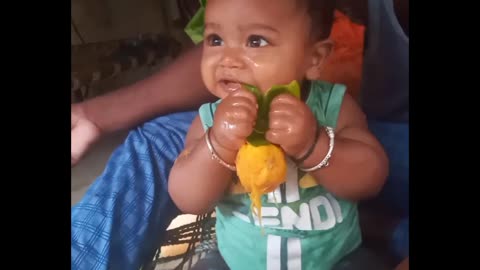 Small baby with mango eating