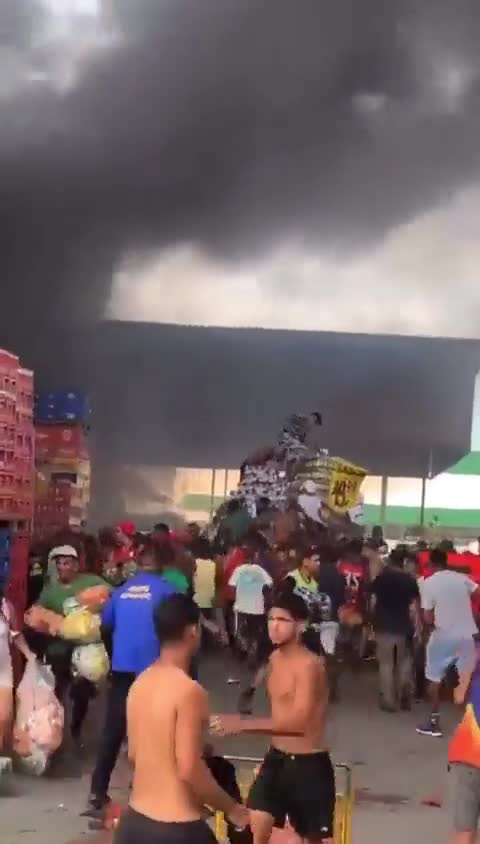 Warehouses at Rio de Janeiro's main food distribution center are on fire in Brazil, sparking riots with reported food looting.
