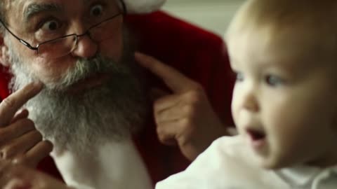 Santa Claus Making Faces With A Baby