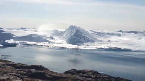 Ilulissat Icefjord - Large iceberg breaking over