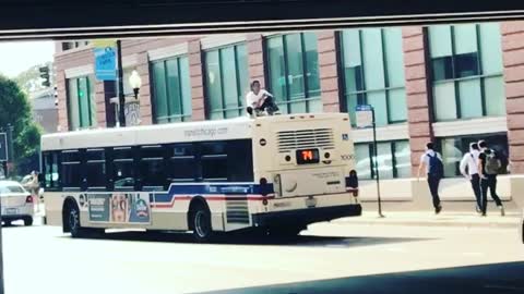 Guy Rides on Top of a Bus