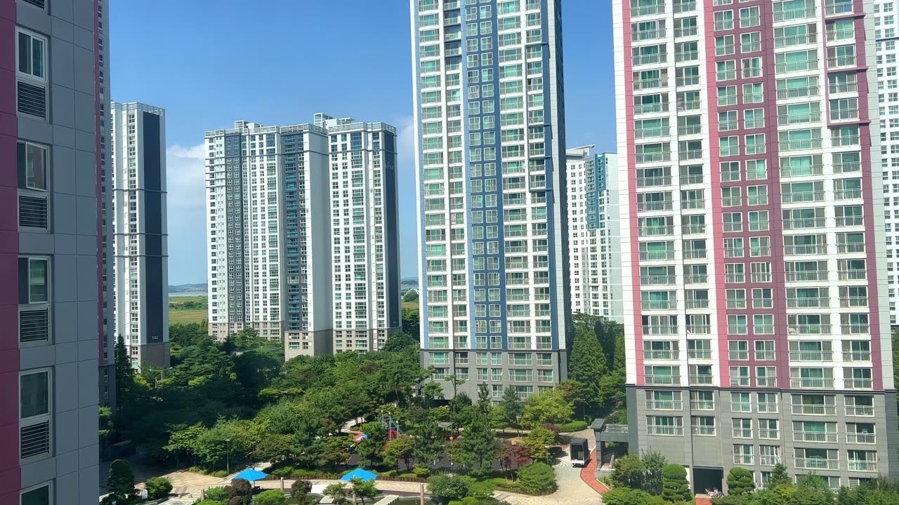 a residential complex with clear skies and high-rise apartments