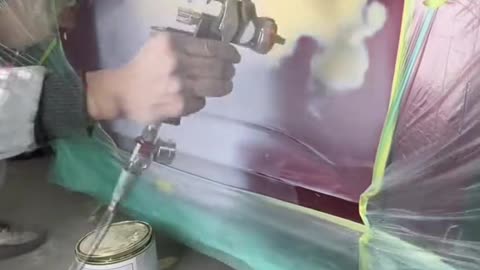 Paint repairing a red car