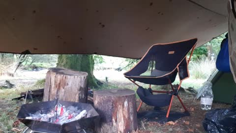 Getting the embers ready to cook burgers and sausages..riverside wildcamping