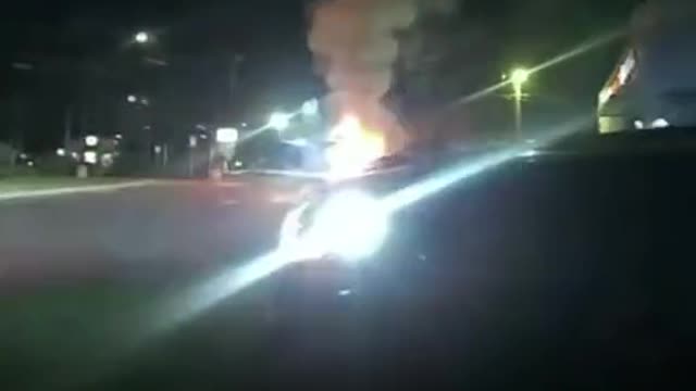 police jumped to the rescue after a passenger was stuck inside a burning car.