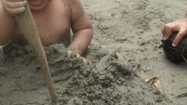 my son 2 years old playing at the beach