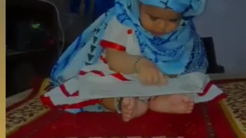 a little girl taking the name of allah