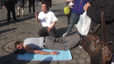 Luodong Massages Black Man On Sidewalk