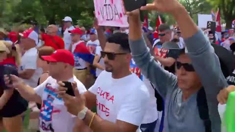 Cuban demonstrators outside the White House have chased out a reporter.