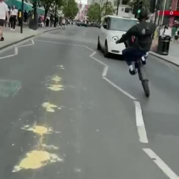 Dude does a wheelie in traffic and finds out