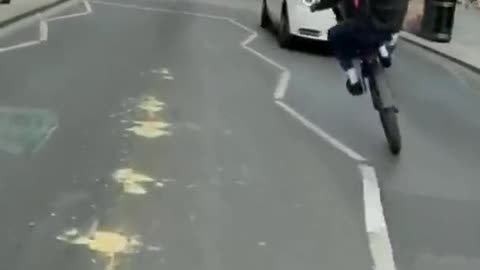 Dude does a wheelie in traffic and finds out