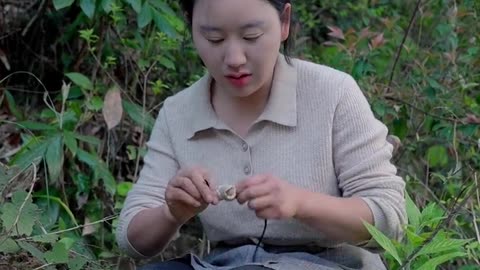 Chinese woman digs bamboo shoots