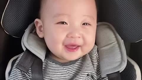 A cute baby coughing and smiling wide