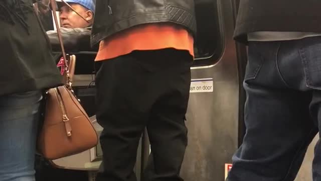 Leather jacket man dances into window on subway