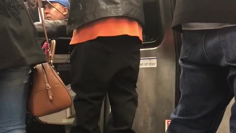 Leather jacket man dances into window on subway