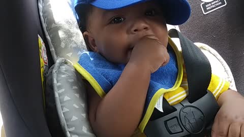 Baby laughs while sucking his thumb