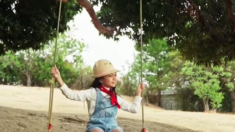 a girl is swinging