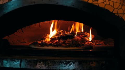 Cooking pizza in a traditional oven