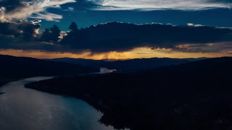 Thick Clouds Of The Sky Reflections On A River -