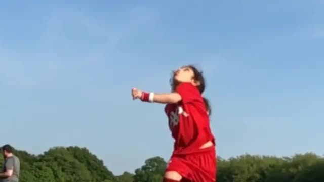 A small little girl back flip Soccer kick