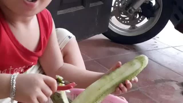 My son helps parents to peel melon