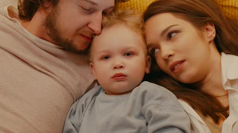 parents-reading-a-book-for-their-daughter-