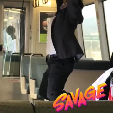 Guy in suit does pull ups on train
