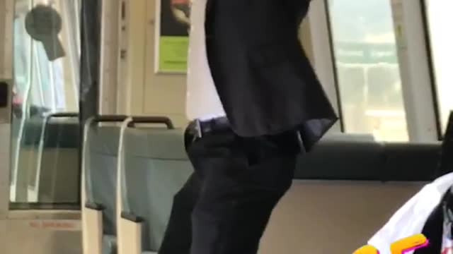 Guy in suit does pull ups on train