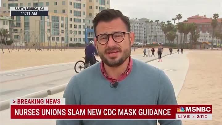 Man on Bike Eats Pavement in Background of MSNBC Live Reporting