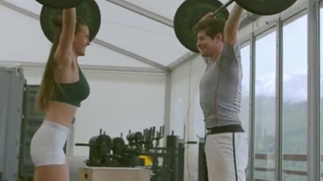 Couple Lifting a Barbells