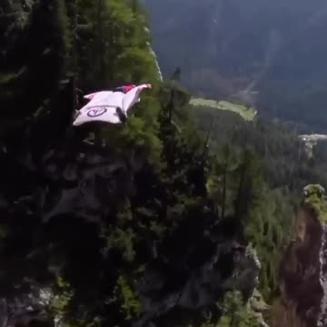 Wing auit Flight in between MOUNTAINS