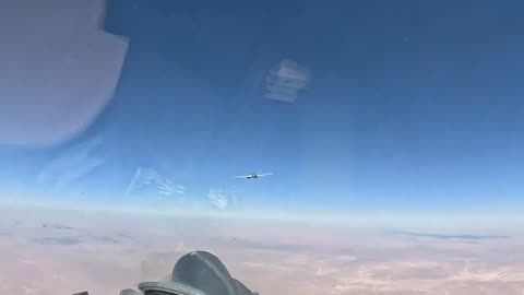 A Russian Su-35S flies next to an American MQ-9 Reaper UAV in the skies of Syria.