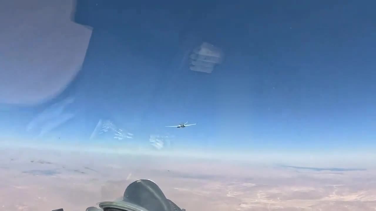 A Russian Su-35S flies next to an American MQ-9 Reaper UAV in the skies of Syria.