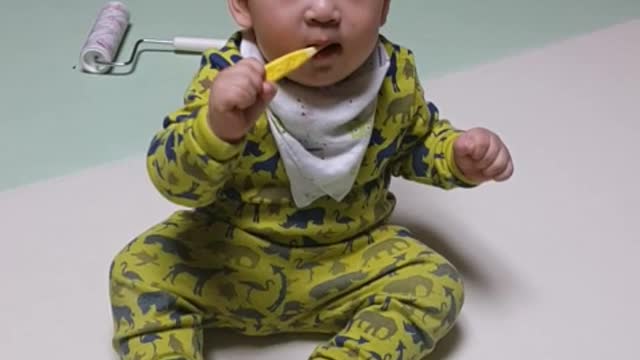 This is a video of a baby practicing brushing teeth.