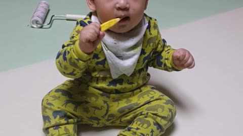 This is a video of a baby practicing brushing teeth.