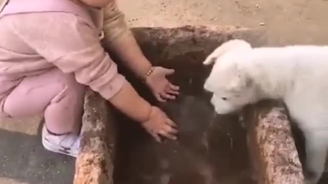 Funny baby playing with water imitating the puppy