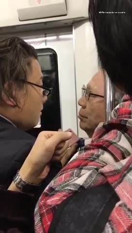 Two men glasses pushing each other on subway